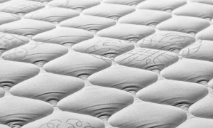 嬰兒透氣床墊推薦 a close up of a mattress that has been made